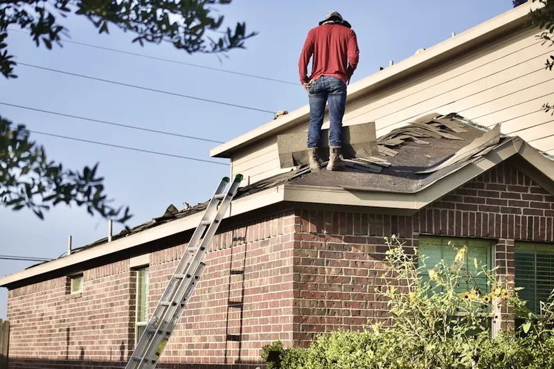 Professional roofer working on a residential roof in Kyburz